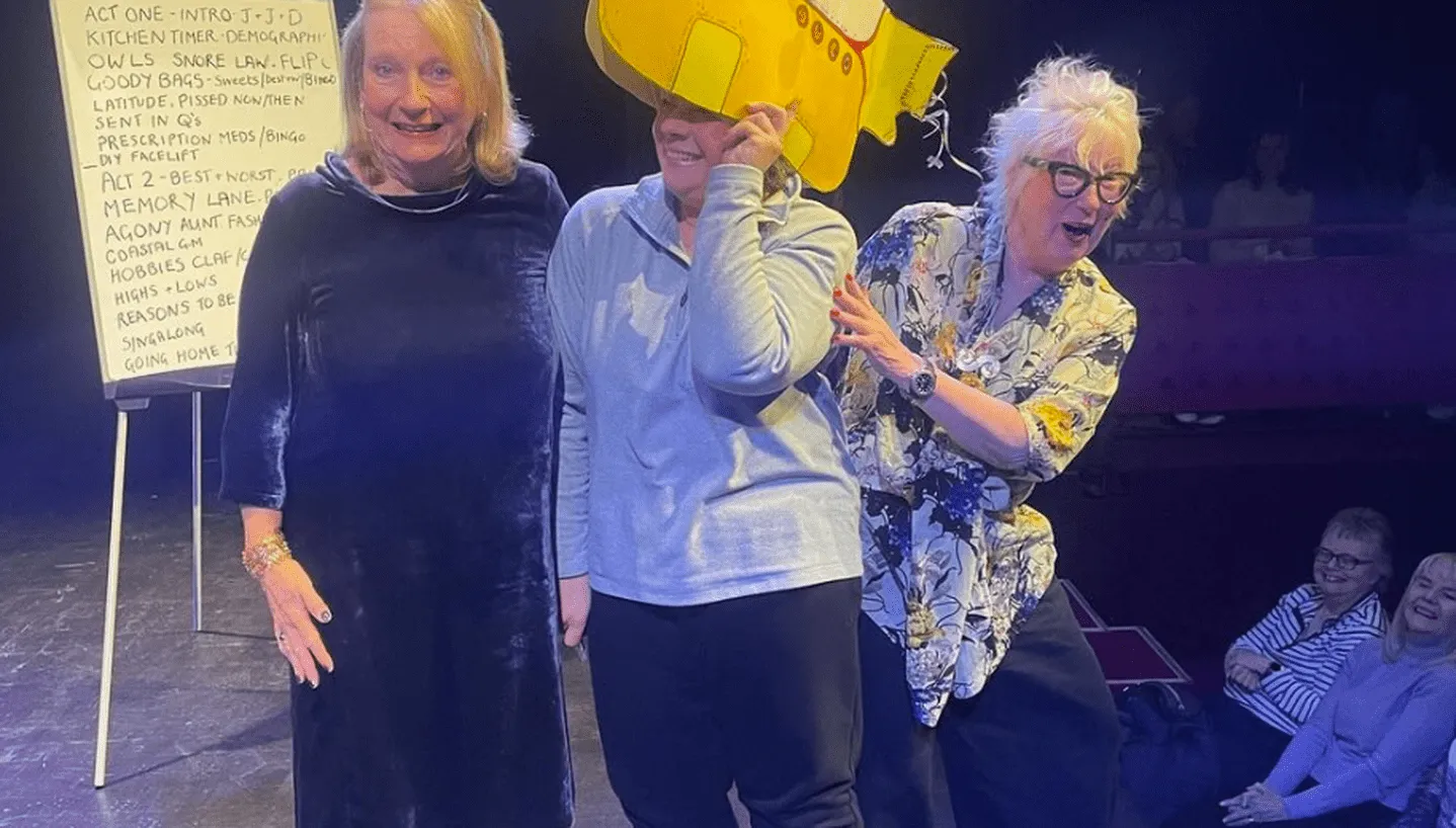Jenny Eclair and Judith Holder with a gang member at a live show
