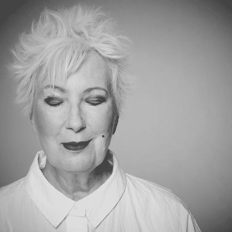 A black and white picture of Jenny Eclair with her eyes closed.