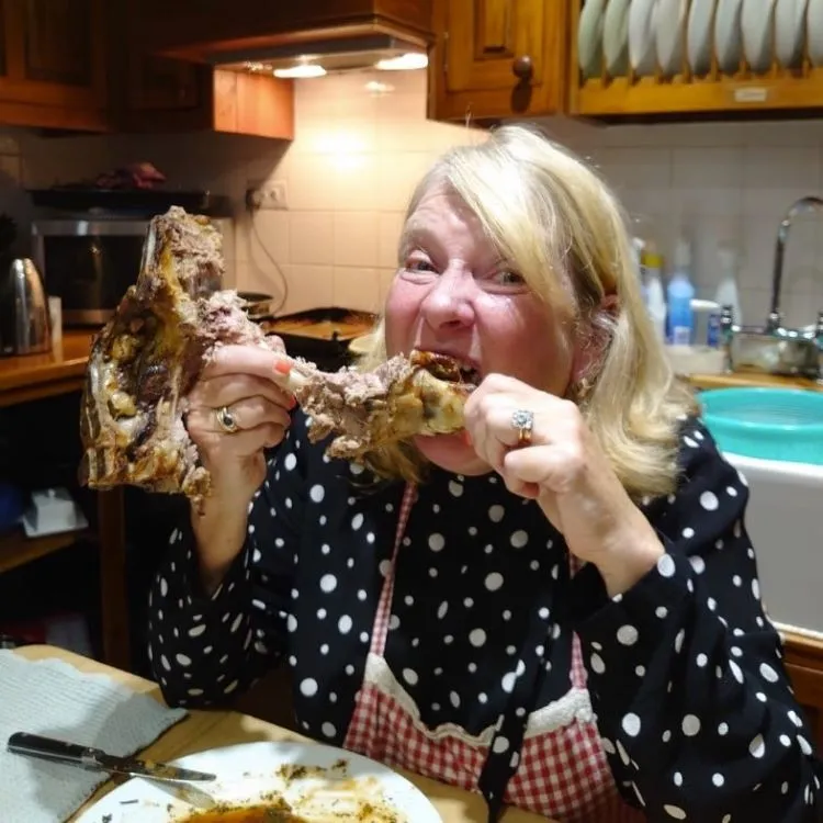 Judith Holder sitting in her kitchen chewing a leftover leg of lamb.